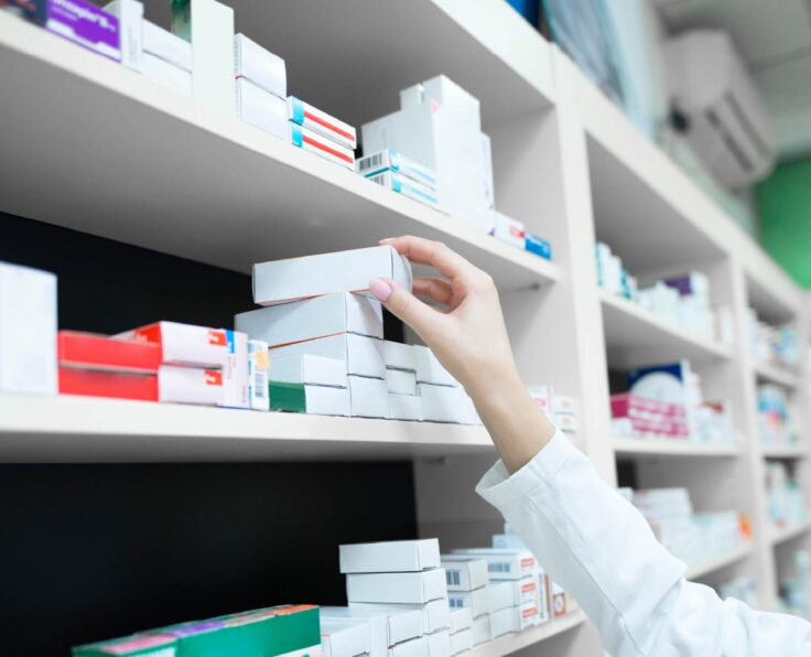 closeup-view-pharmacist-hand-taking-medicine-box-from-shelf-drug-store (1)